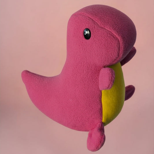 A pink plush dinosaur toy with a yellow belly and a small black safety eye, shown against a soft pink background.