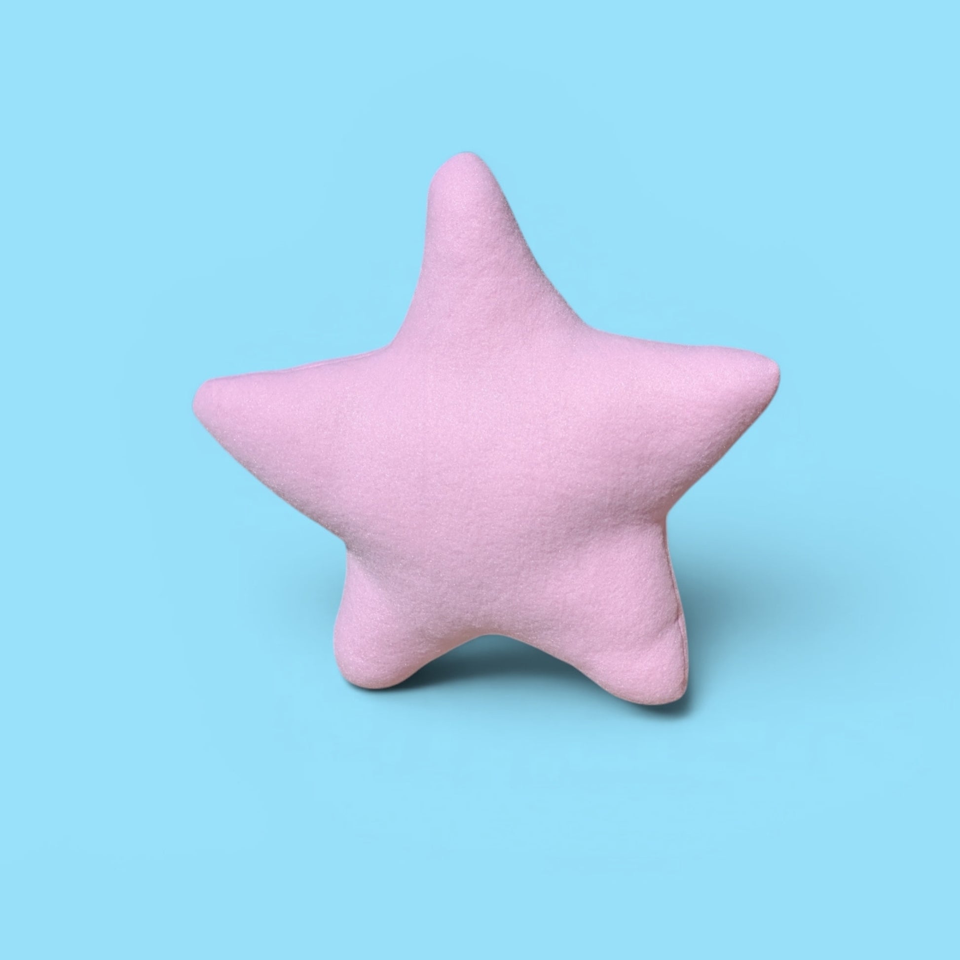 A pink star-shaped plush stuffed animal toy centered on a solid light blue background.