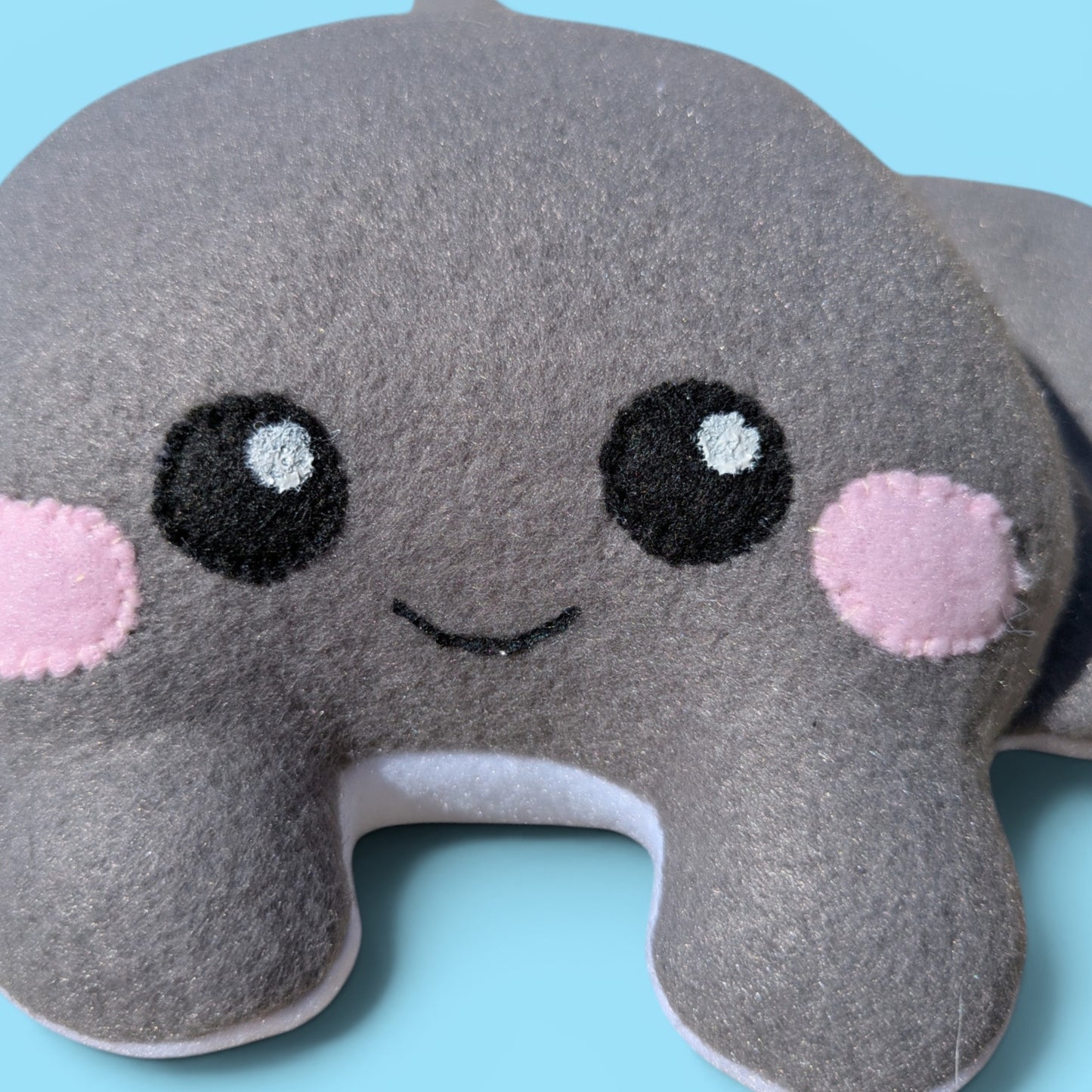 Close up of plush stingray stuffed animals face with felt eyes and cheeks