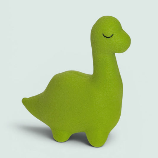 A bright lime green dinosaur-shaped plush toy with a simple black embroidered closed-eye detail, standing on a light gray background.